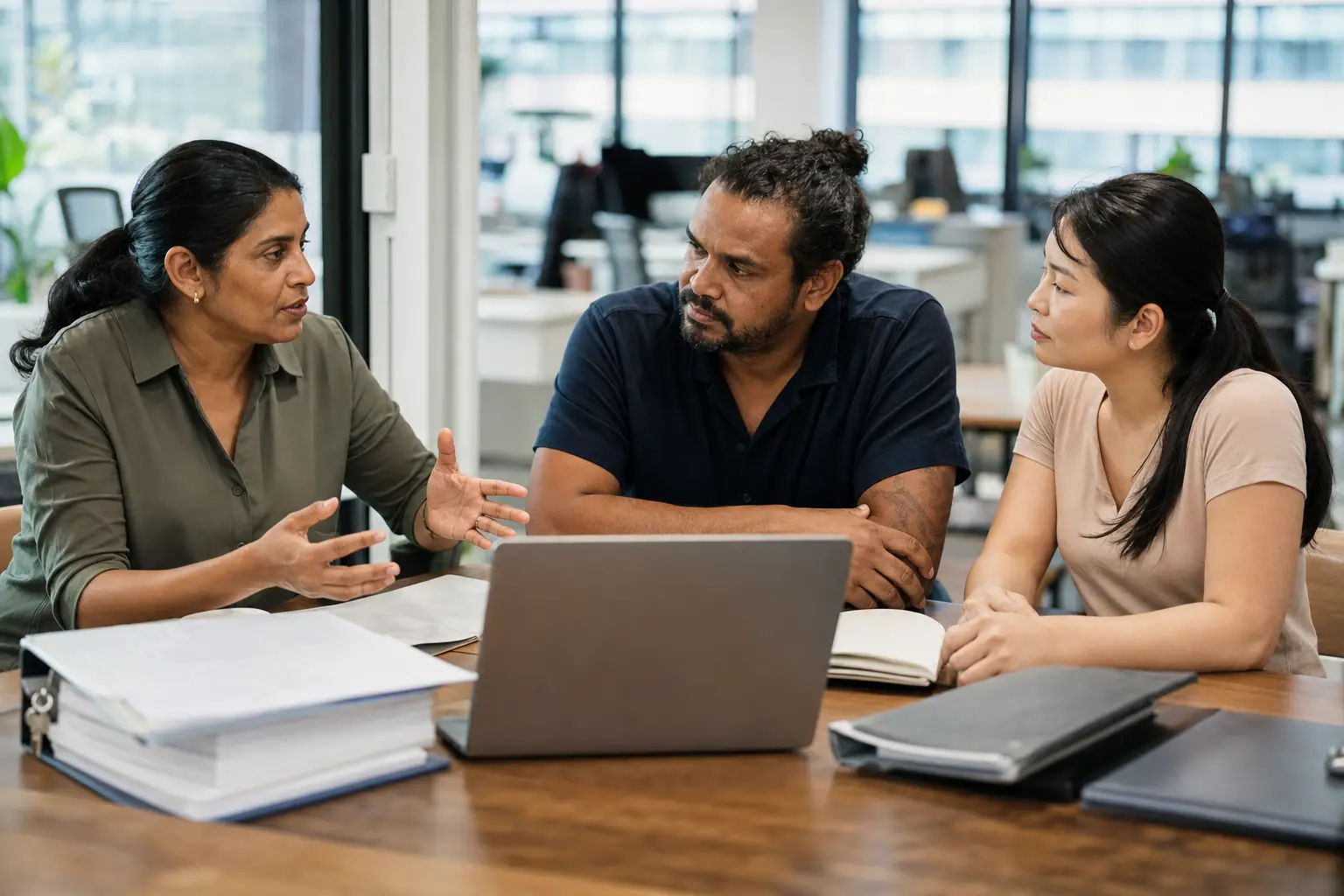 An RTO team reviewing enrolments and compliance evidence together in a modern Australian training office.